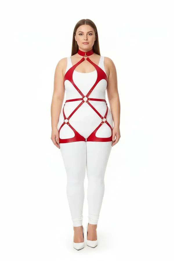 Red faux leather full body harness with gold O-ring details spanning neck to thigh on a plus-size model over white outfit