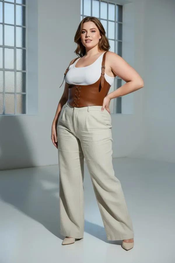 tan faux leather underbust corset harness with lace-up front and wide adjustable shoulder straps worn over white top