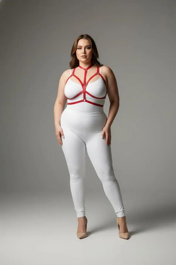 Red vegan leather strappy chest harness with geometric cage straps and silver O-ring on plus-size model