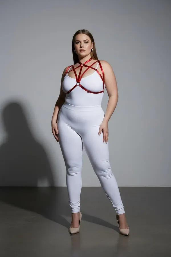 red strappy chest harness with O-ring junctions and collar band worn over white bodysuit plus size model