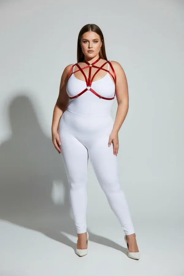 red strappy chest harness with O-ring junctions and collar band worn over white bodysuit plus size model