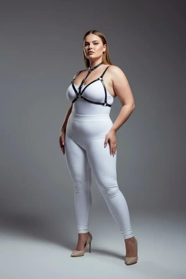 strappy black faux leather body harness with collar strap and silver buckles worn over white bodysuit