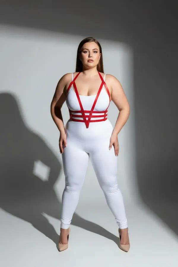 red faux leather strappy body harness with four horizontal chest bands and silver hardware worn by plus-size model
