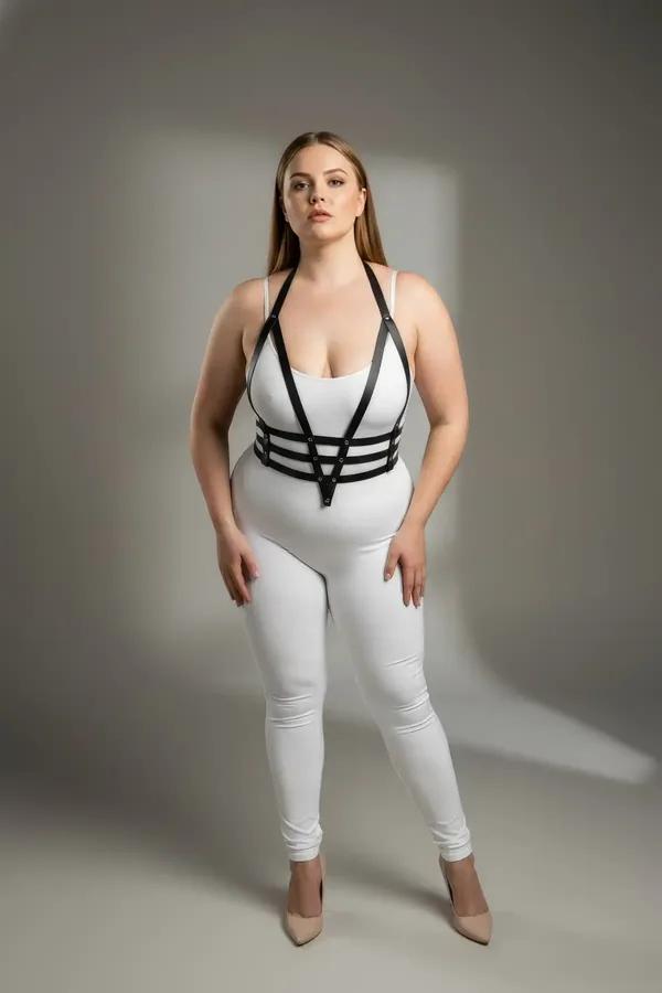 black vegan leather strappy body harness with V-strap shoulders and triple underbust cage bands, silver center stud hardware