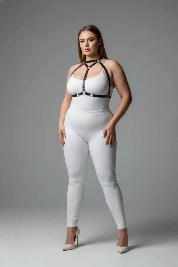 black faux leather strappy body harness with silver O-rings and collar strap worn over white outfit