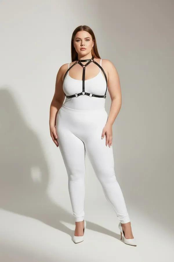 black faux leather strappy body harness with silver O-rings and collar strap worn over white outfit