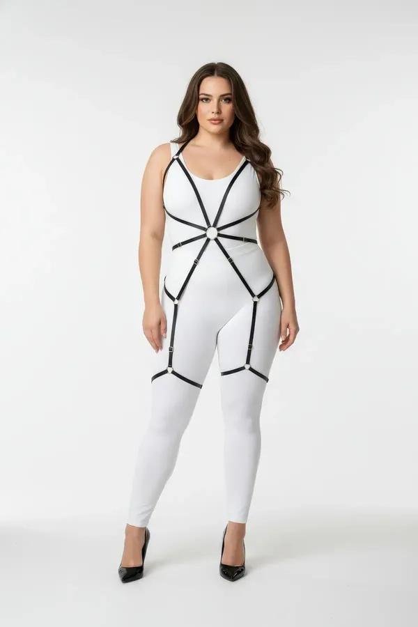 Black faux leather full body harness with gold O-ring chest detail and thigh strap cages worn over white bodysuit