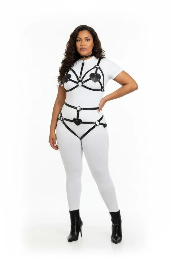 black faux leather harness bra and garter set with heart cut-out panels and silver O-rings on plus-size model