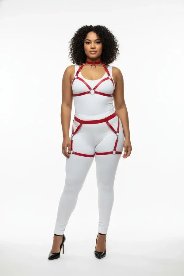 Red faux leather full body harness with silver O-ring choker, chest frame, and thigh garter straps on plus-size model