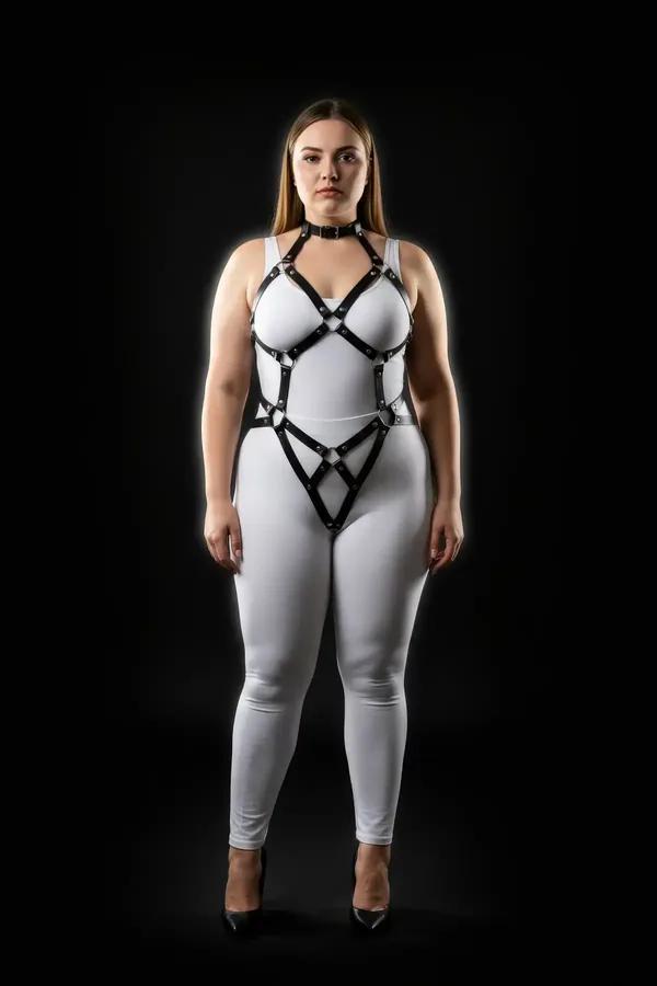 black faux leather adjustable o-ring body harness with geometric cage chest and hip straps on plus-size model