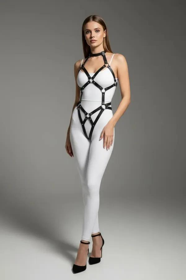 Black faux leather full body harness with silver O-ring accents, choker collar, and geometric strap design worn over white bo