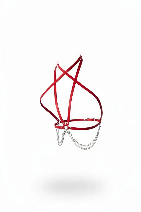 red faux leather strappy chest harness with crossed front straps and draped silver chains on white background