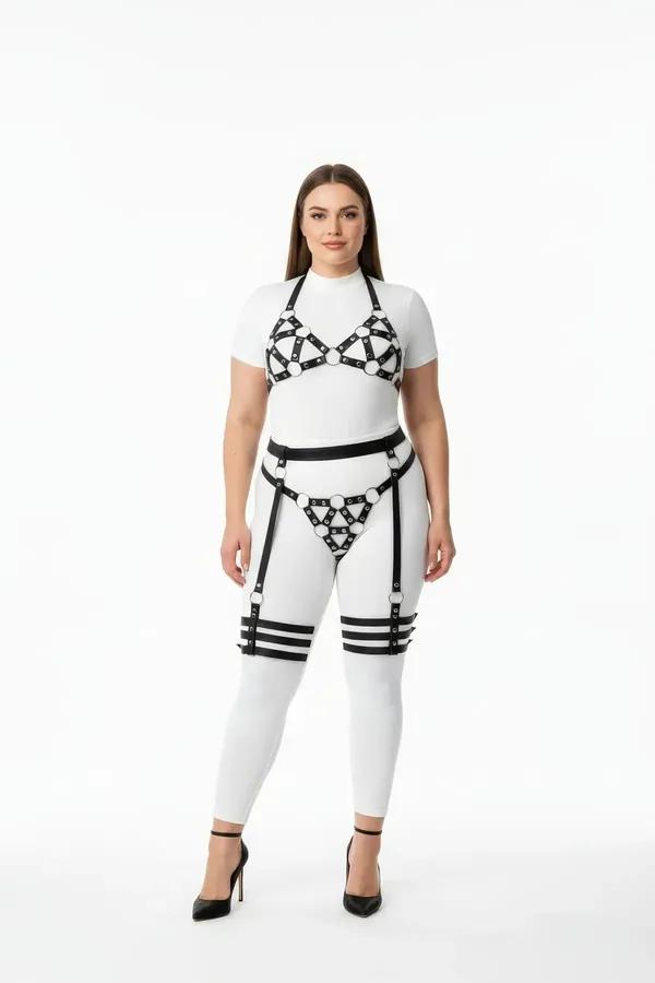 black faux leather geometric o-ring harness set with detachable garter straps worn over white fitted outfit