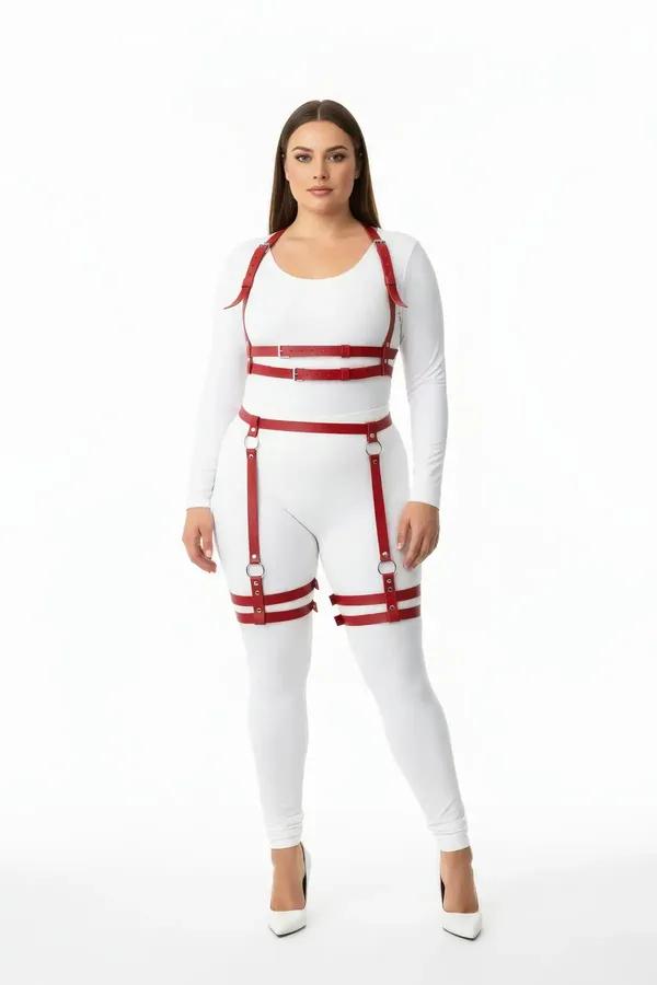 Red faux leather full body harness with dual thigh straps and silver O-ring buckles worn over white base layers