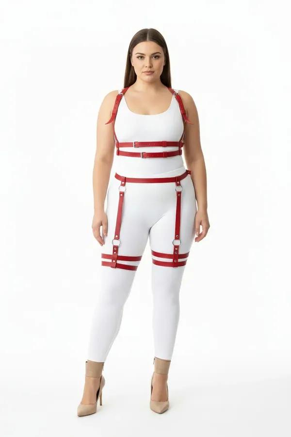 Red faux leather full body harness with dual thigh straps and silver O-ring buckles worn over white base layers