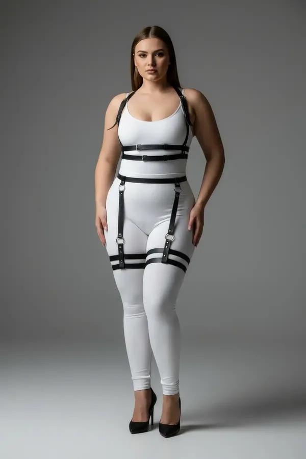black faux leather body harness with garter straps worn over grey tank and jeans, double thigh bands and chest cage visible