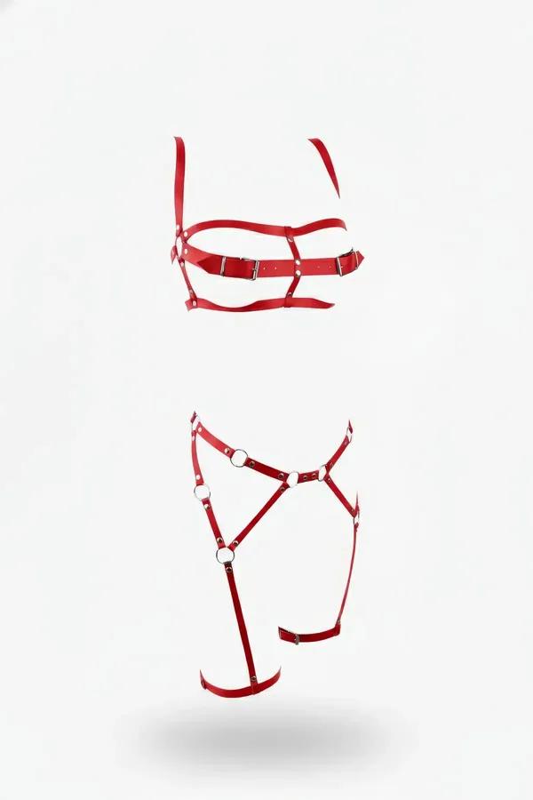 red faux leather ring detail harness set with silver O-ring garter thigh piece laid flat on white background