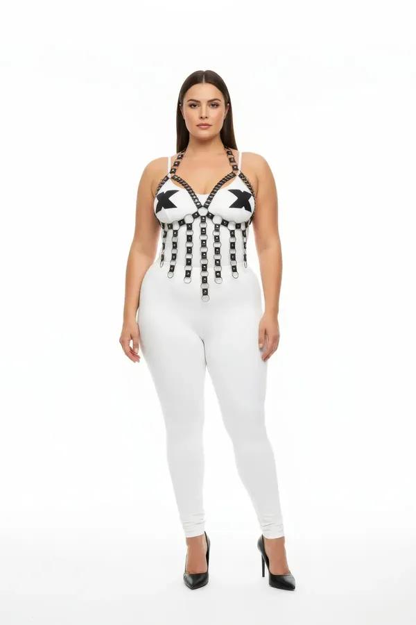 White strappy chest harness with cascading black faux leather straps and silver O-ring accents worn over white leggings