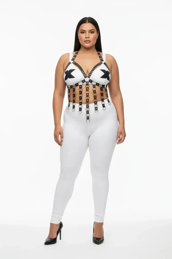 White strappy chest harness with cascading black faux leather straps and silver O-ring accents worn over white leggings