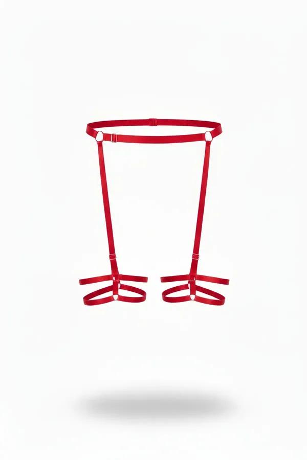 Red strappy garter harness with silver O-rings and dual adjustable leg bands on white background