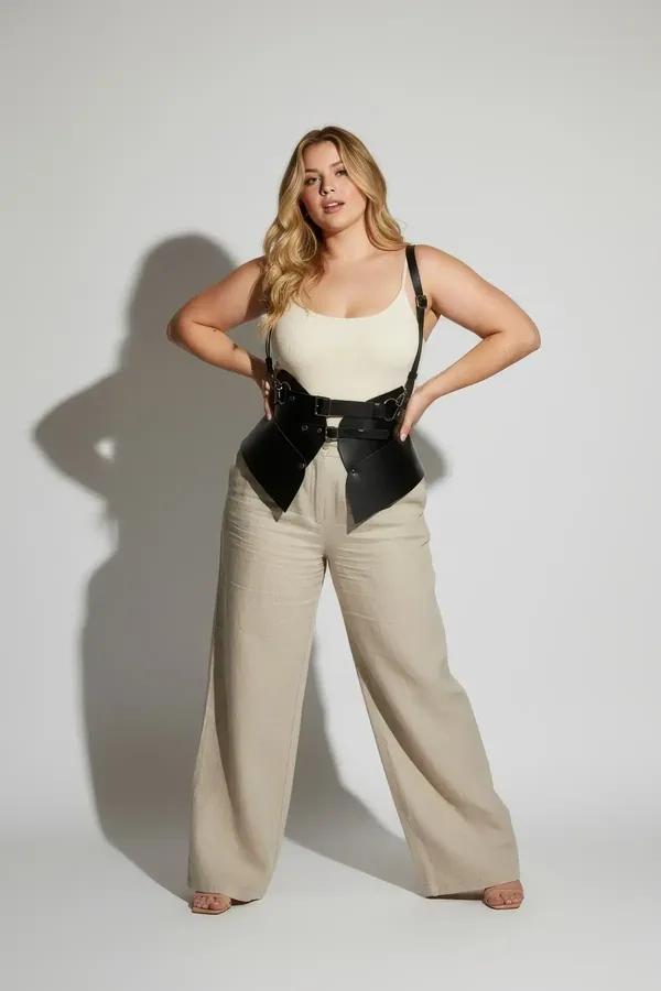black faux leather corset harness belt with structured waist panels silver buckles and pointed front hem worn over white tank