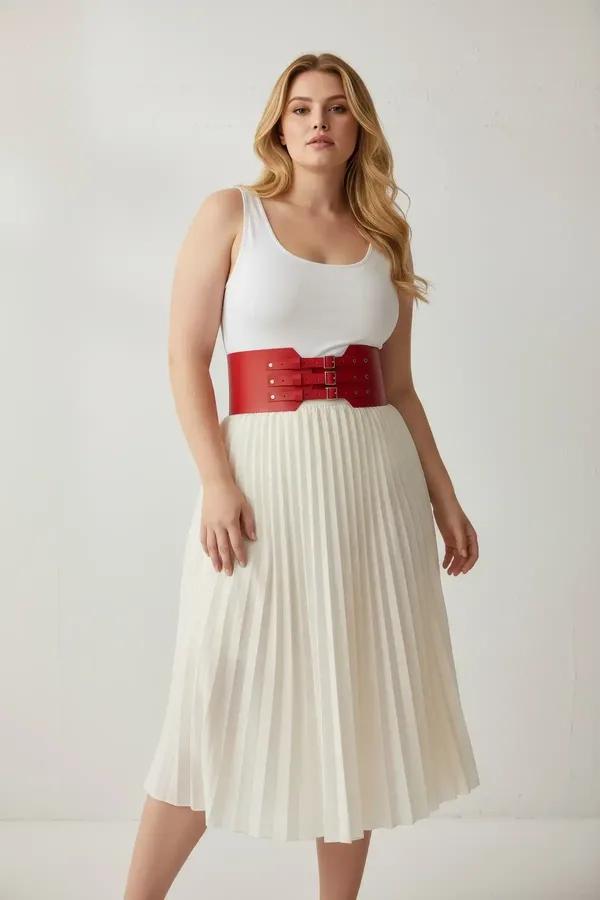 red faux leather wide corset waist harness belt with gold double buckles and decorative metal studs worn over cream top and p