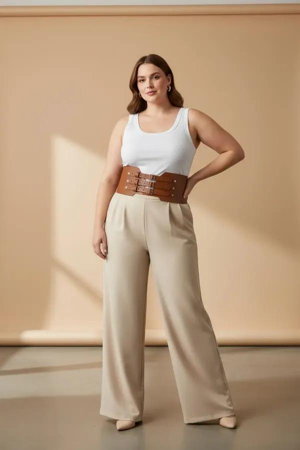 tan faux leather corset waist harness with three stacked silver buckles worn over cream tank and linen trousers