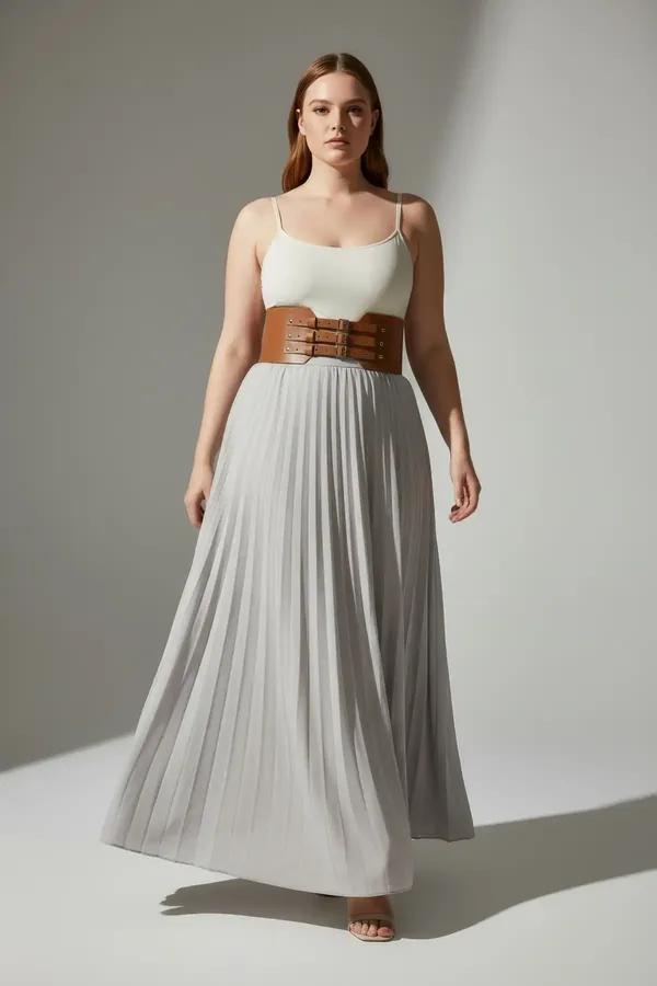 tan faux leather corset waist harness with three stacked silver buckles worn over cream tank and linen trousers