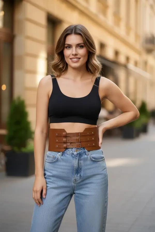 tan faux leather triple buckle waspie waist belt with silver-tone pin buckles worn over black crop top and jeans