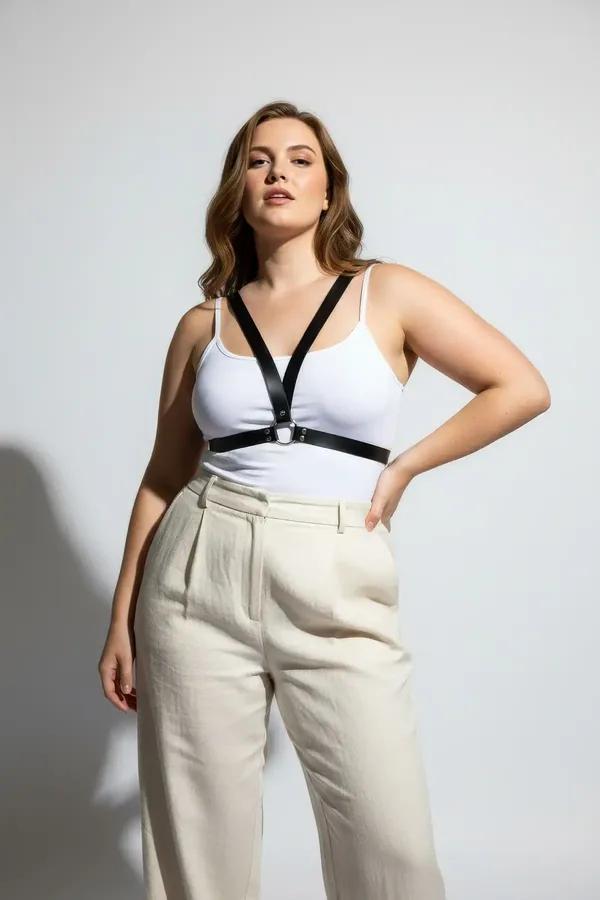 black faux leather minimalist chest harness with silver O-ring underbust band worn over white top street style