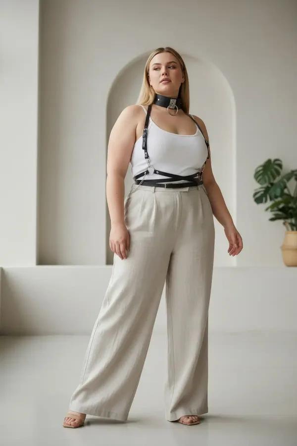 black faux leather body harness with gold O-ring choker and waist belt worn over white tank top