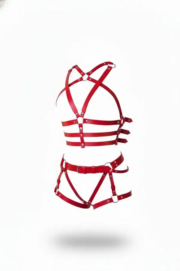 Red faux leather cage harness set with silver O-rings, showing chest harness and waist-thigh piece on white background