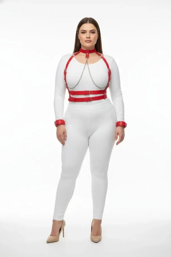 red faux leather chest harness and collar set with silver drape chains and wrist cuffs worn over white bodysuit