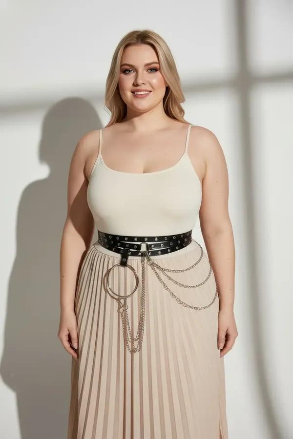 black faux leather grommet waist harness belt with silver O-ring and layered chains worn at natural waist