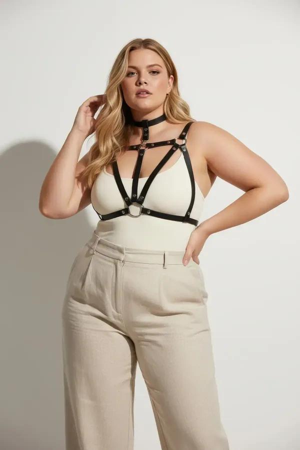 black faux leather cage chest harness with integrated choker and silver O-ring detail worn over cream top