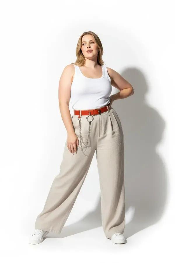claret red faux leather belt with double silver O-rings and draped chain worn over white wide-leg trousers
