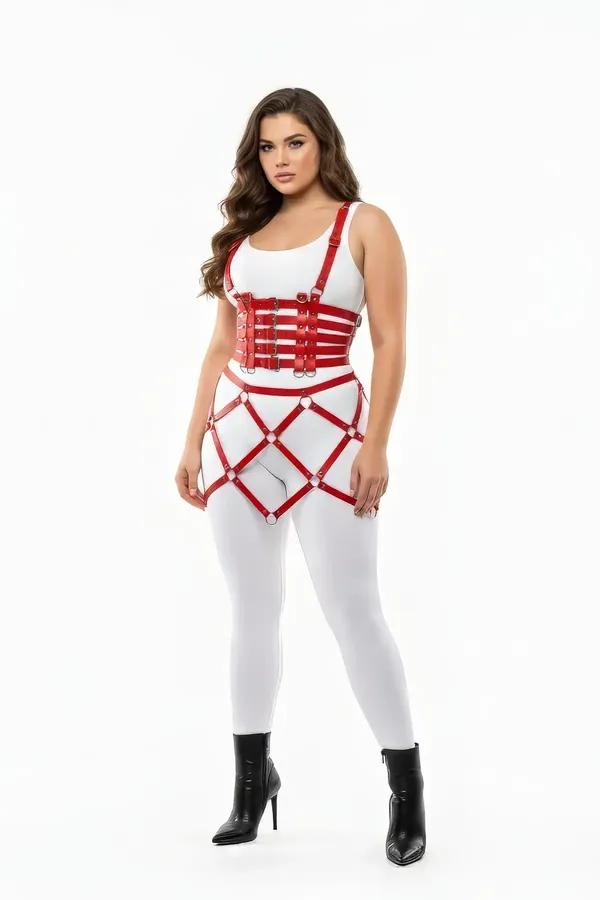 Red faux leather caged harness skirt and bustier set with silver O-rings worn over white bodysuit and leggings