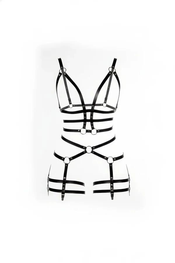 Black faux leather full body harness with silver O-ring detail, chest cage and adjustable thigh bands, front view on white ba