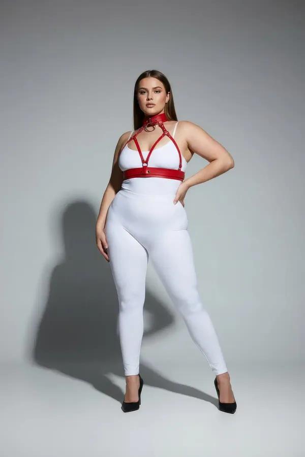 red faux leather strappy chest harness with matching choker collar and gold O-ring on plus size model