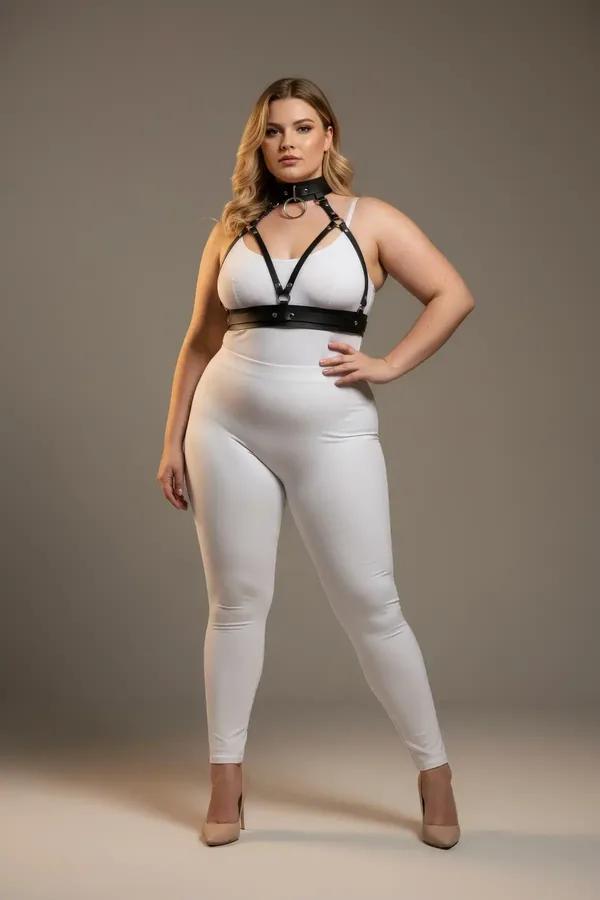 black faux leather o-ring choker and chest harness set with gold hardware worn over white bralette plus size model