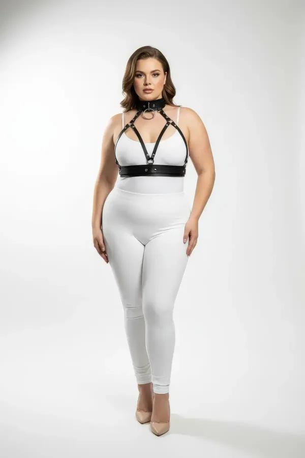 black faux leather o-ring choker and chest harness set with gold hardware worn over white bralette plus size model