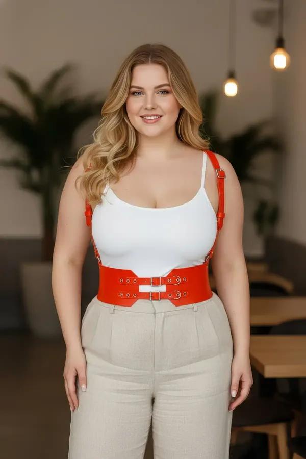 red faux leather wide waist harness with double silver buckles and adjustable shoulder straps worn over white tank top