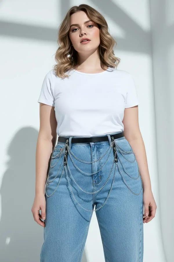 black faux leather multi-chain draped waist belt with silver hardware worn over light-wash jeans