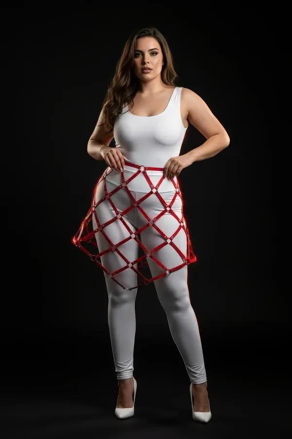 red faux leather lattice cage skirt harness with silver O-ring connectors worn over white leggings, A-line diamond grid silho