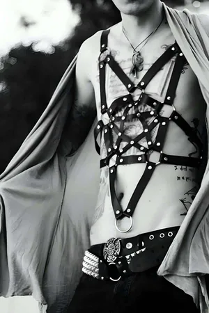 Black faux leather star cage body harness with O-ring accents and adjustable straps