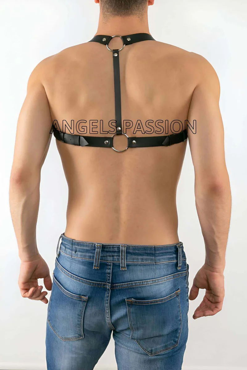 Close-up of black faux leather chest harness buckle and O-ring