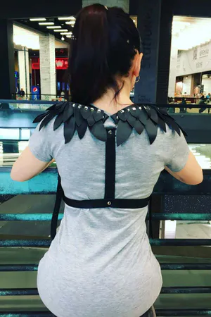 Black Faux Leather Shoulder Harness with Layered Wing Detail worn over grey t-shirt, back view.