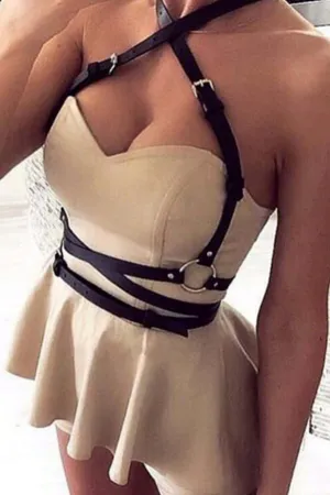 Black Faux Leather Body Harness Women Adjustable Straps Silver O-Ring Detail Over Beige Dress