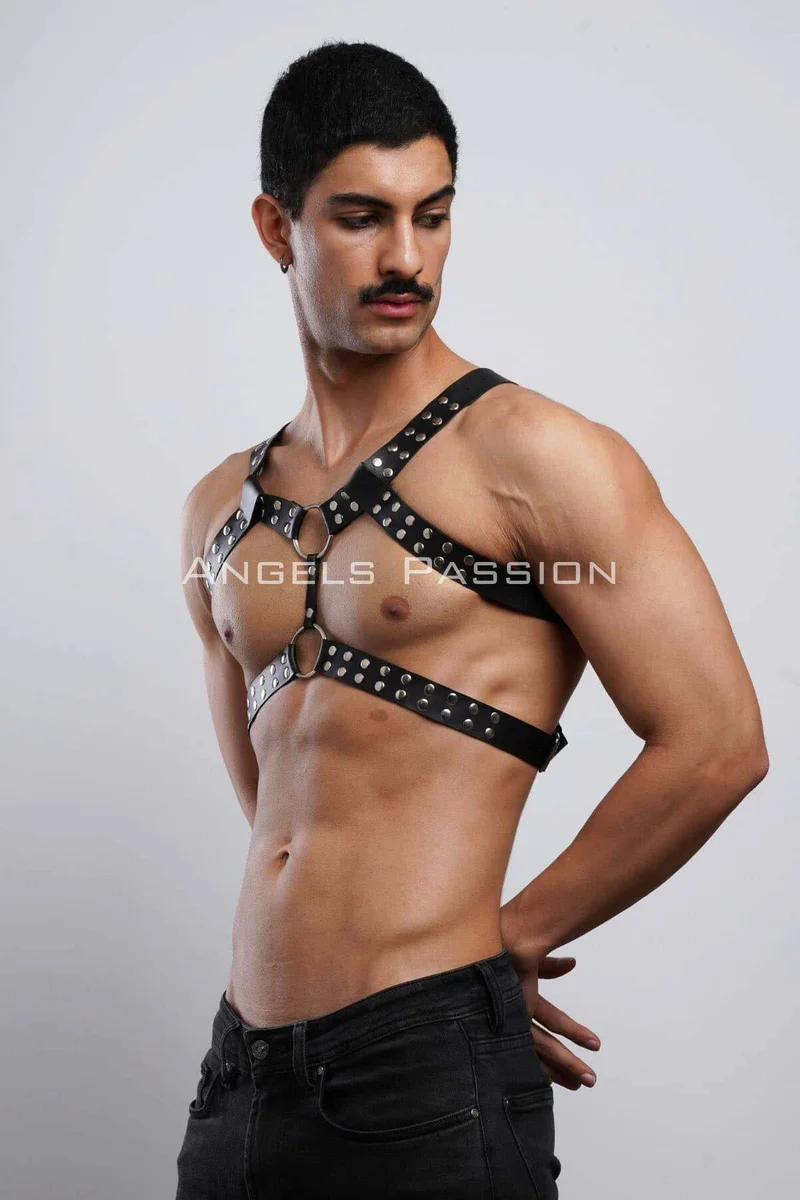Black faux leather full body harness on male model showing front straps and studs