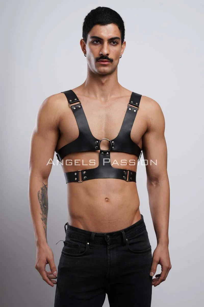 Close-up of black faux leather chest harness O-ring and strap buckle